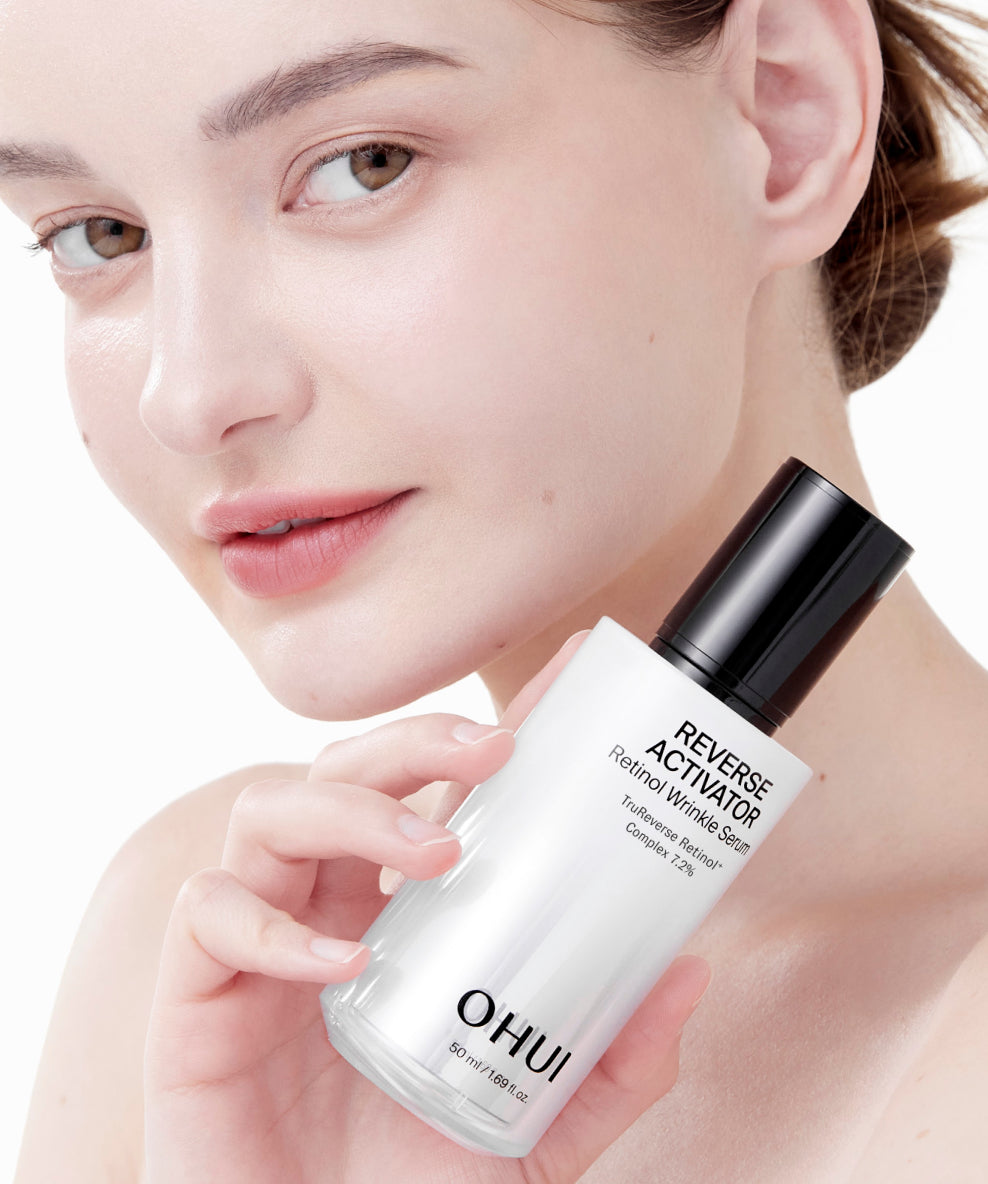A model holding a bottle of Reverse Activator Retinol Wrinkle Serum