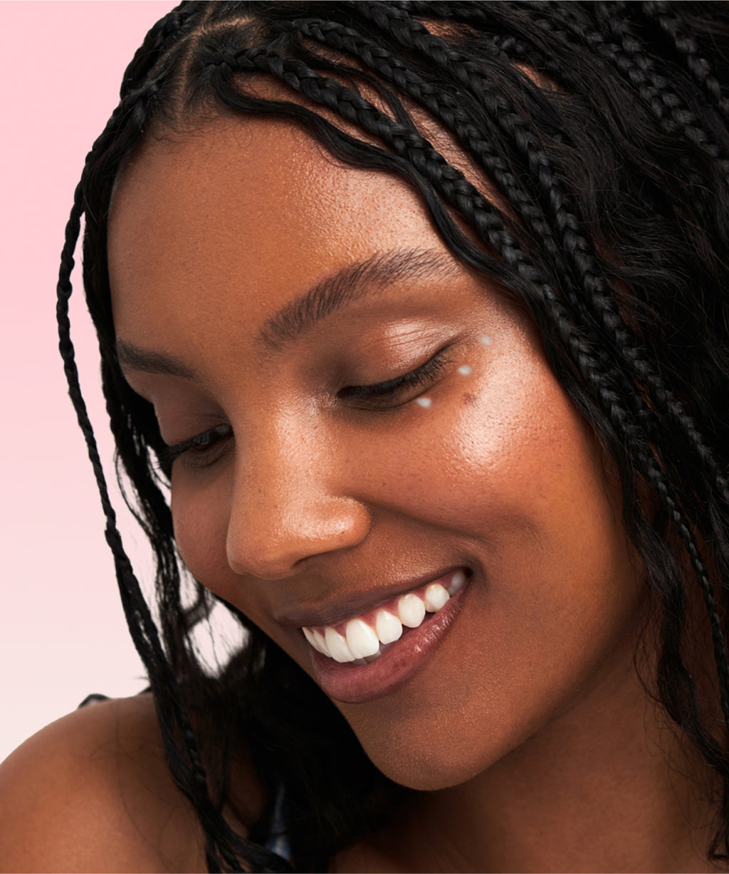 Model applying The Face Shop Rice Water Bright Vegan Eye Cream to under-eye area – Achieve a refreshed and radiant look