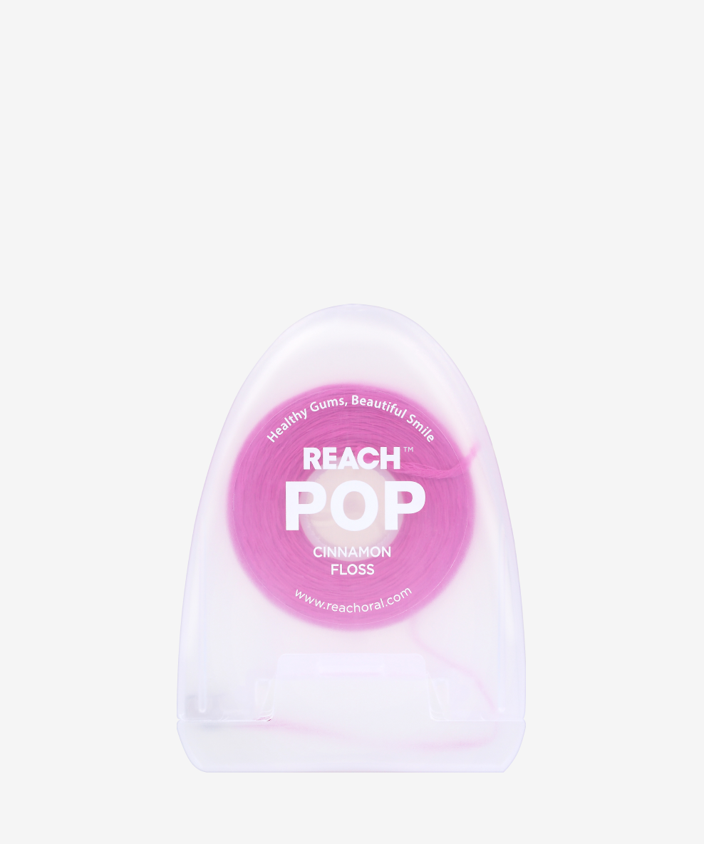 A container of Reach POP Floss Cinnamon on a white background