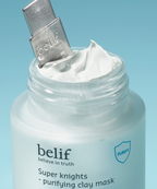 An image showing the applicator and open jar of the Super Knights purifying clay mask.