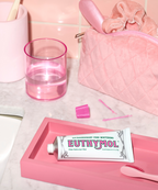 An image showing a bathroom counter with the Euthymol Whitening Toothpaste on a pink tray.